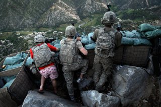 Soldiers from the U.S. Army First Battalion, 26th Infantry take defensive positions at firebase Restrepo after receiving fire from Taliban positions in the Korengal Valley of Afghanistan's Kunar Province, in this May 11, 2009 file photo. Spc. Zachery Boyd of Fort Worth, TX, far left was wearing 